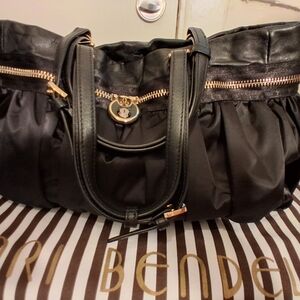 HENRI BENDEL Vintage handbag. Black satin and leather handbag with padlock.